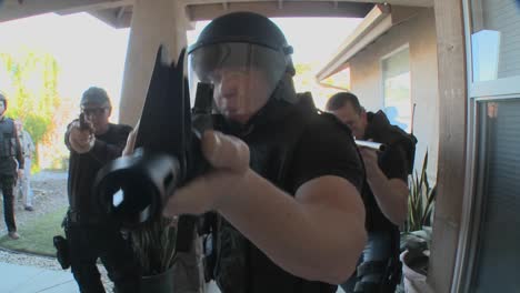 DEA-officers-with-arms-drawn-perform-a-drug-raid-on-a-house-2