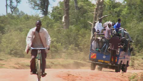 Ein-Mit-Passagieren-überfüllter-Van-Fährt-Auf-Einer-Unbefestigten-Straße-In-Ostafrika