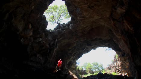 A-Masai-warrior-standing-in-a-deep-cave-in-Kenya
