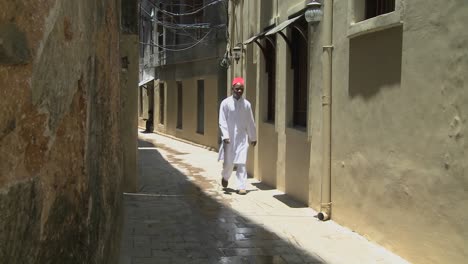 A-Muslim-man-walks-in-the-narrow-alleys-of-Stone-Town-Zanzibar