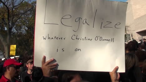 A-person-holds-up-a-sign-saying-legalize-whatever-Christine-ODonnell-is-on-at-the-Jon-Stewart-rally