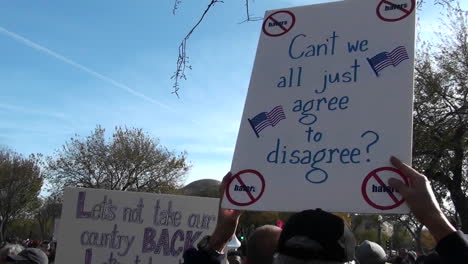 People-at-a-political-rally-hold-up-signs-urging-the-country-to-move-forward