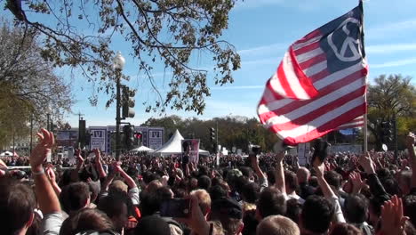 Protestors-fly-a-huge-American-flag-with-a-peace-sign-on-it-in-Washington-DC