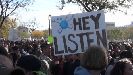 A-sign-at-a-huge-political-rally-says-Hey-Listen