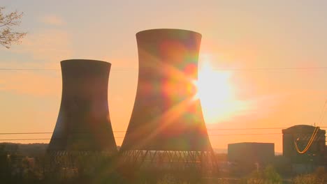 Time-lapse-shot-of-the-sun-setting-behind-a-nuclear-power-plant