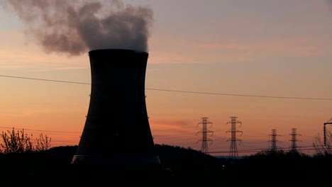 Time-lapse-shot-of-the-sun-setting-behind-a-nuclear-power-plant-1