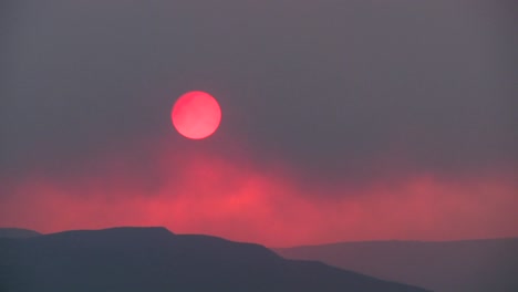 The-sun-sets-behind-a-smokey-red-horizon