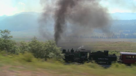 Traveling-shot-of-a-steam-train-moving-through-the-Rocky-Mountains