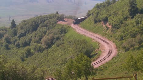 A-high-angle-view-of-a-steam-train-going-around-a-curve-in-the-Rocky-Mountains