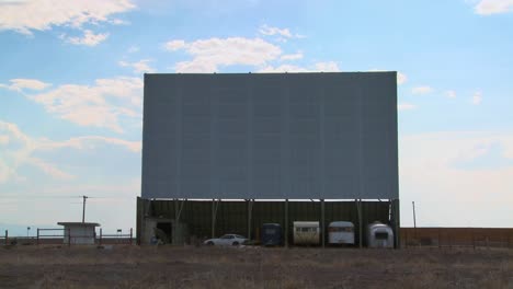 A-shot-of-clouds-passing-over-an-abandoned-drive-in-theater-screen-1