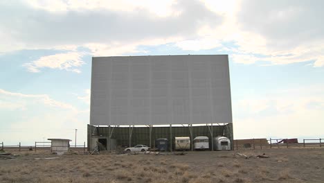 A-shot-of-clouds-passing-over-an-abandoned-drive-in-theater-screen-3