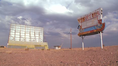 Clouds-pass-over-an-abandoned-drive-in-sign-and-screen