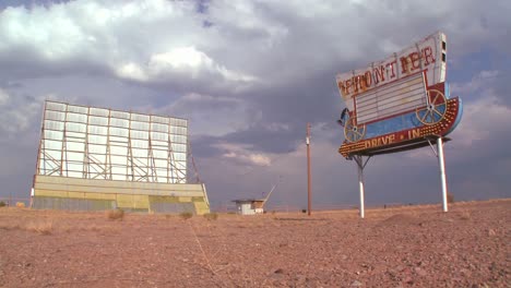 Clouds-pass-over-an-abandoned-drive-in-sign-and-screen-1