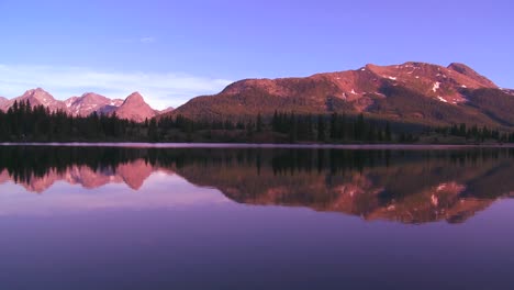The-Rocky-Mountains-are-perfectly-reflected-in-an-alpine-lake-at-sunset-or-dawn-1