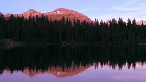The-Rocky-Mountains-are-perfectly-reflected-in-an-alpine-lake-at-sunset-or-dawn-2