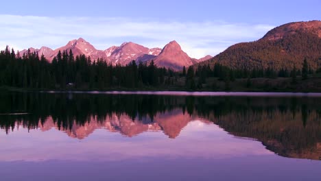 The-Rocky-Mountains-are-perfectly-reflected-in-an-alpine-lake-at-sunset-or-dawn-3