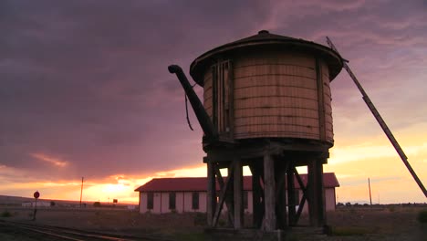 A-water-towers-along-an-abandoned-railroad-track-at-dusk