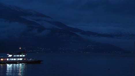A-boat-crosses-a-dark-lake-at-night