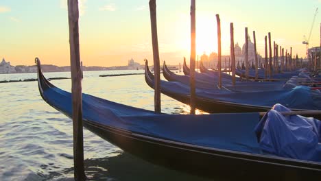 A-beautiful-shot-of-the-sun-setting-behind-rows-of-gondolas-in-Venice-Italy-1