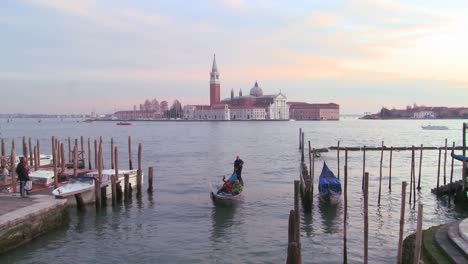 A-gondola-is-rowed-in-front-of-Isola-di-San-Giorgio-Maggiore-in-Venice-Italy