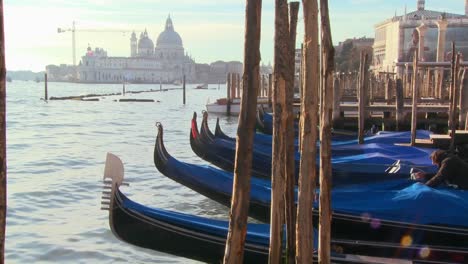 Rows-of-gondolas-line-a-canal-in-Venice-Italy