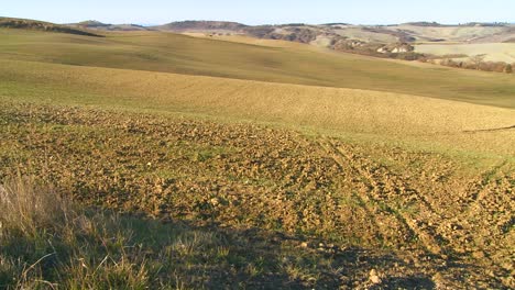 A-slow-pan-across-fallow-fields-in-Tuscany-Italy