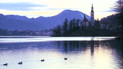 Una-Pequeña-Iglesia-En-Una-Isla-Al-Amanecer-En-El-Lago-Bled-Eslovenia-7
