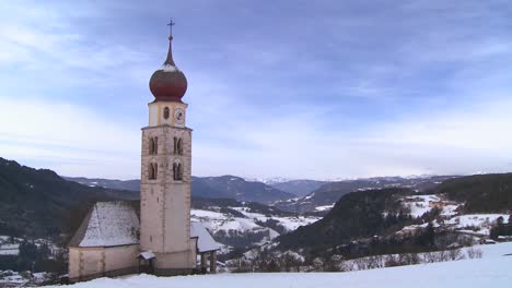 Zeitrafferwolken-über-Einer-Ostkirche-In-Einem-Verschneiten-Tiroler-Dorf-In-Den-Alpen-In-Österreich-Schweiz-Italien-Slowenien-Oder-Einem-Osteuropäischen-Land