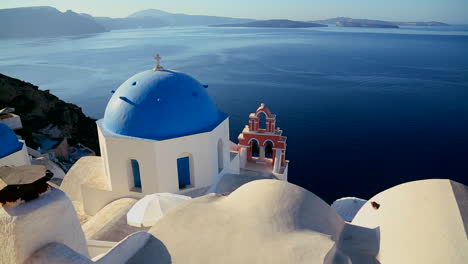 Pan-across-Greek-Orthodox-church-on-the-Greek-island-of-Santorini