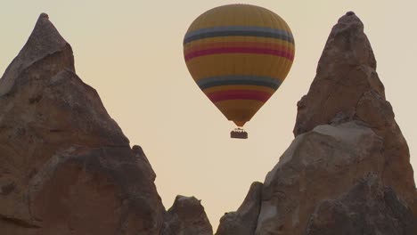 A-hot-air-balloon-flies-through-a-narrow-canyon-in-Cappadocia-Turkey