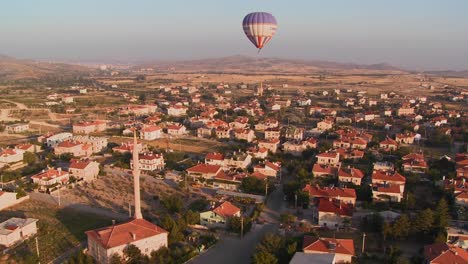 Hot-air-balloons-fly-over-a-neighborhood-near-Cappadocia-Turkey