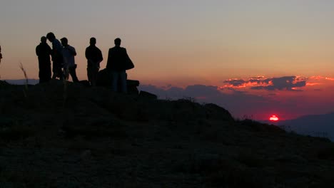 People-stand-in-silhouette-at-sunrise-of-sunset-on-the-summit-of-Mt-Nemrut-Turkey