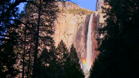 A-beautiful-waterfall-in-Yosemite-National-park-casts-a-rainbow