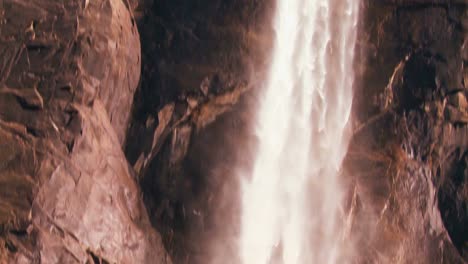 Tilt-down-to-follow-water-flowing-from-s-a-beautiful-waterfall-in-Yosemite-National-park