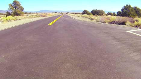 POV-shot-along-a-desert-road-conduciendo-fast