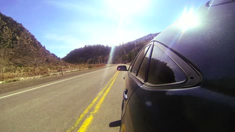 POV-shot-driving-fast-along-a-mountain-road-with-the-car-visible
