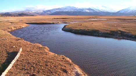 Pan-across-a-beautiful-mountain-river-and-valley-in-the-Sierra-Nevada-mountains