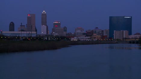 The-city-of-Indianapolis-Indiana-at-dusk-with-the-White-River-foreground