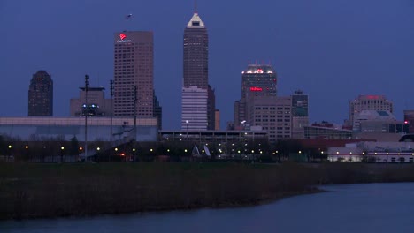 The-city-of-Indianapolis-Indiana-at-dusk-with-the-White-River-foreground-1