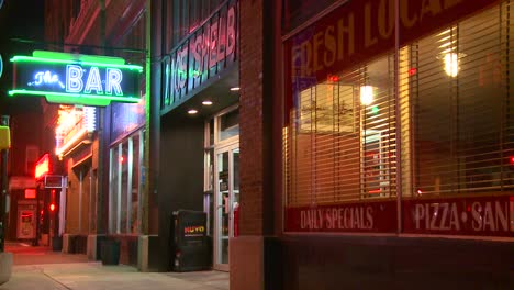 An-empty-city-street-with-a-neon-bar-sign