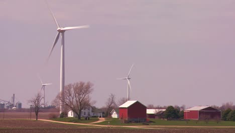 Giant-windmills-generate-power-behind-farms-in-the-American-midwest