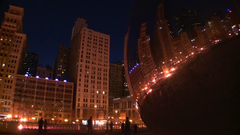 Downtown-Chicago-skyline-at-night-reflected-partly-in-the-Bean-at-Millennium-park