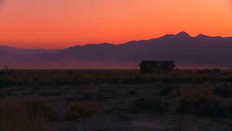 The-sun-sets-behind-an-abandoned-cabin-the-desert-1