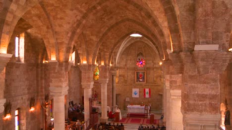 A-tilt-down-from-the-ceiling-of-a-church-to-a-Catholic-or-Maronite-Church-ceremony-in-Lebanon