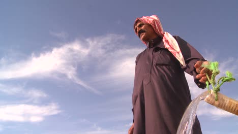 Tilt-up-as-a-Bedouin-provides-precious-water-for-his-flocks-in-the-dry-desert-mountains-of-the-Holy-land