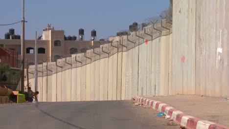 A-street-winds-along-the-base-of-the-new-West-Bank-Barrier-between-Israel-and-the-Palestinian-territories