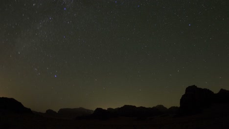 An-incredible-time-lapse-shot-looking-up-at-an-arch-formation-in-the-desert-against-a-night-sky-1
