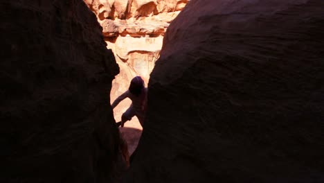 A-Bedouin-man-climbs-up-on-cliffs-in-Wadi-Rum-Jordan