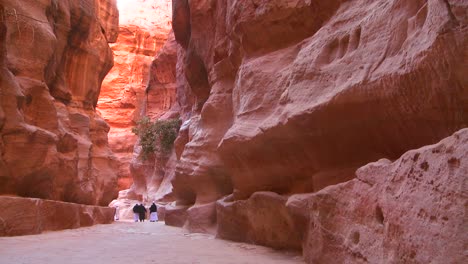 Arab-men-walk-through-the-narrow-canyons-leading-up-to-Petra-Jordan-1