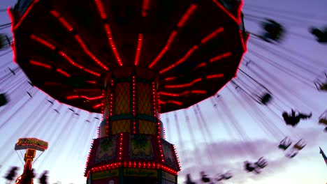 A-merry-go-round-spins-with-riders-against-the-sky
